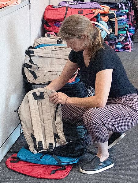 Woman Filling backpack